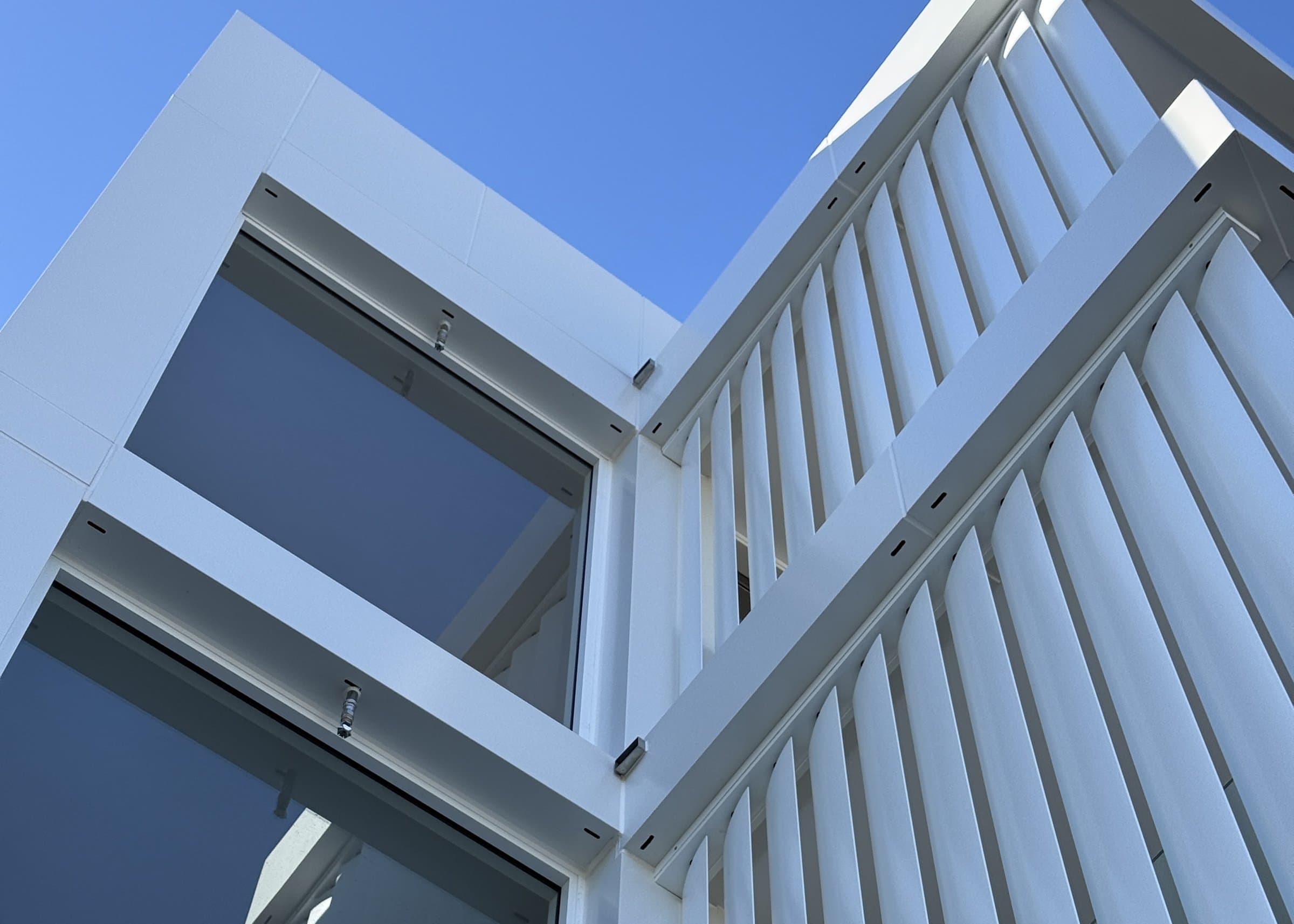 White aluminium facade and sunshade louvres on a Renew Construction Group project in Sydney